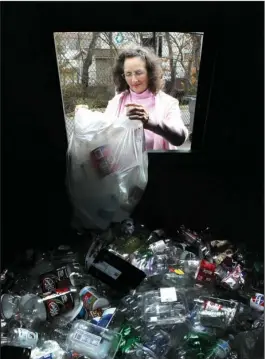  ?? The Sentinel-Record/Richard Rasmussen ?? FUNDING SHORTFALL: Kelly Martin, of Royal, dumps plastic into a container at the Southwest Central Regional Solid Waste Management District’s recycle center on Runyon Street Thursday. The district said it will not fund the center after June 30.