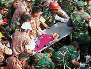  ??  ?? Turning point: Rescuers pulling out a female survivor, Reshma, alive out of the collapsed Rana Plaza building in 2013. Five years on, the tragedy has spurred one of the region’s strongest movements to organise and help workers exercise collective...