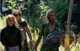  ?? Jonny Cournoyer/Paramount Pictures ?? Millicent Simmonds, left, Noah Jupe and Emily Blunt in “A Quiet Place Part II,” written and directed by Blunt’s husband, actor John Krasinski.