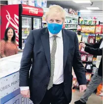  ??  ?? STRICTER
Boris Johnson wore face covering on visit to businesses