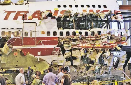  ??  ?? HAUNTING REMINDER: The ghostly wreckage of TWA Flight 800 sits in a hangar in Ashburn, Virginia.