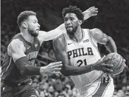  ?? Laurence Kesterson / Associated Press ?? 76ers center Joel Embiid, right, scored 32 of his 39 points in a dominant first-half effort against Detroit.