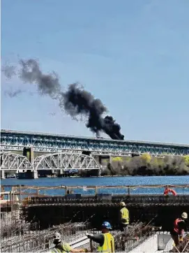  ?? CT State Police/Contribute­d photo ?? Portions of the southbound Gold Star Memorial Bridge remain closed after a truck carrying heating oil collided with the disabled car, causing the truck to overturn and igniting its 2,200 gallons of heating oil.