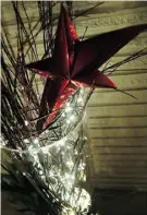  ?? Edmonton Journal/file ?? Mini lights woven between branches and topped with a glittering ornament bring festive beauty to the condo balcony.