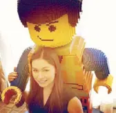 ?? ?? Holding onto Emmet Brickowski, a popular Lego figure.