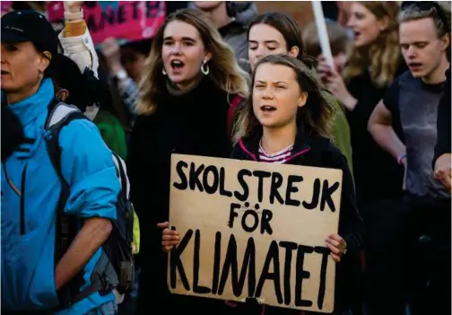  ?? Age nce France -Pre sse ?? Swedish climate activist Greta Thunberg (centre) marches during a ‘Fridays for Future’ movement protest in Stockholm, Sweden.