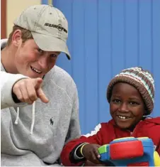  ??  ?? Prince Harry jokes with a toddler at centre for abused children in Maseru, Lesotho in 2008.