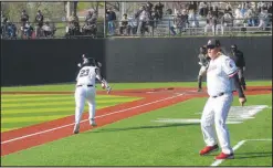  ?? Daniel Bereznicki/McDonald County Press ?? Head coach Heath Alumbaugh waves on Kreighton Kasischke (No. 23) to run to home base, scoring the team’s first run.