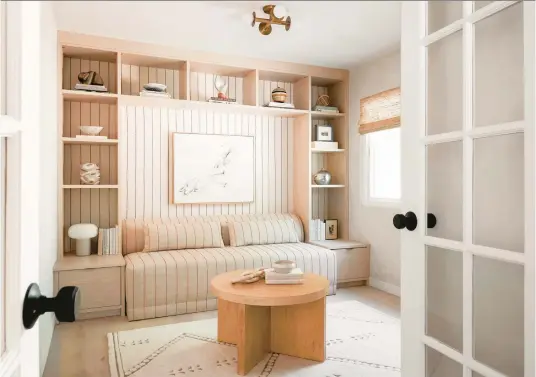  ?? ANNE SAGE ?? A home office features an inviting bookshelf-filled space, enveloping the walls and the sofa in a textural stripe upholstery fabric from Crypton Home.