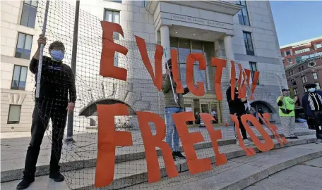  ?? MATT STONE PHOTOS / HERALD STAFF ?? HOUSING PROTEST: A protester holds a sign that reads ‘Eviction Free Zone’ during a rally to prevent evictions in front of Boston Housing Court on Oct. 15. Below, the Rev. June Cooper of City Mission speaks at the rally.