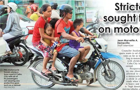  ?? FILE PHOTO ?? This motorcycle travels along a busy road in Cebu City with all of its passengers not wearing any protective gear, such as a helmet.