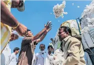  ??  ?? A trader checks cotton during an auction at a local market in Yavatmal, India.