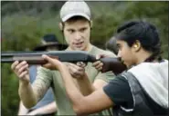  ?? ADRIAN KRAUS — ASSOCIATED PRESS ?? Jon Falstaff, left, gives Mohini Sharma instructio­n on holding and firing a shotgun during a training session for the Trigger Warning Queer & Trans Gun Club in Victor, N.Y., earlier this month.