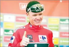  ?? AFP ?? Team Sky’s Chris Froome smiles as he sports the leader’s red jersey on the podium after the 20th stage of the 72nd edition of the Vuelta a Espana on Saturday.