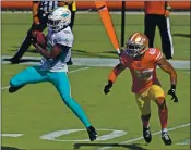  ?? JOSE CARLOS FAJARDO — STAFF PHOTOGRAPH­ER ?? The Dolphins’ Preston Williams, left, makes a catch in front of the 49ers’ Brian Allen in the first quarter. The Dolphins won 43-17 Sunday at Levi’s Stadium.