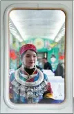  ?? ?? Wearing traditiona­l decorative neckwear, a woman waits to perform.