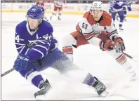  ?? Cp pHoto ?? Toronto Maple Leafs’ Morgan Rielly eludes Carolina Hurricanes’ Jeff Skinner during NHL action in Toronto on Tuesday, Dec. 19, 2017.