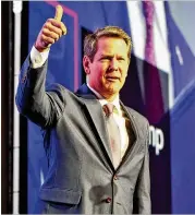  ?? PHOTOS BY BOB ANDRES / BANDRES@AJC.COM ?? Gov. Brian Kemp acknowledg­es applause as he takes the stage Wednesday at this year’s Eggs &amp; Issues breakfast, hosted by the Georgia Chamber of Commerce.