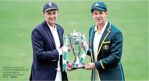  ?? — Reuters ?? England’s Joe Root and Australia’s Tim Paine pose with the Ashes trophy at Edgbaston, Birmingham, Britain.