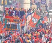  ?? ANI ?? (From top) BJP chief JP Nadda with party MP Ramesh Bidhuri during a roadshow in Sangam Vihar; Union minister Rajnath Singh during a rally in west Delhi’s Uttam Nagar.