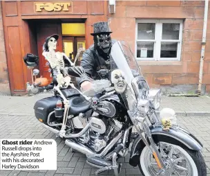  ??  ?? Ghost rider Andrew Russell drops into the Ayrshire Post with his decorated Harley Davidson