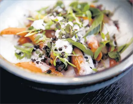  ?? Photograph­s by Gary Coronado Los Angeles Times ?? ERVEN’S roasted carrots with coconut sorbet (instead of yogurt), lentils, Thai herbs and tamarind Sriracha has a Bangkok taste.