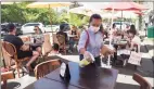  ?? Hearst Connecticu­t Media file photo ?? Rosa Gonzalez wipes down a table in the outdoor dining area at Bistro V in Greenwich in September.