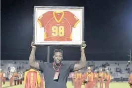  ?? LAUGHLIN/SOUTH FLORIDA SUN SENTINEL MICHAEL ?? NFL Pro Bowl defensive end Jason Pierre-Paul has his Deerfield Beach jersey retired during halftime against St. Thomas Aquinas on Oct. 5, 2018, at Deerfield Beach High School.