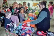  ?? sean Williams ?? A variety of items from gloves, balls and even bicycles were given away in Taylorsvil­le in a Dec. 14 event.