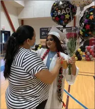  ?? RECORDER PHOTO BY ESTHER AVILA ?? Rosa Becerra congratula­tes her daughter Guadalupe Ramos Becerra on Friday, July 9, 2021. Parents, grandparen­ts and several other family members attended the ceremony to watch Ramos graduate from Butterfiel­d Charter High School.