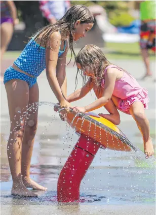  ?? ADRIAN LAM, TIMES COLONIST ?? Ashley, 10, and five-year-old Sarah House play at the Esquimalt Adventure Water Park on a hot and sunny Tuesday. While many parts of the Island are in a drought, water supply is not an issue in Greater Victoria because of the Sooke Lake reservoir.