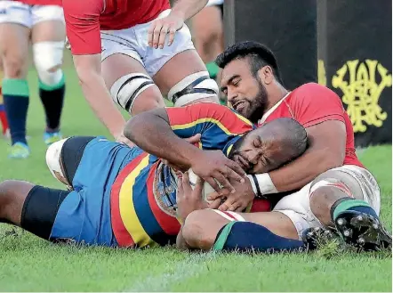  ?? PHOTO: MIKE LEWIS ?? Hurricane Victor Vito pulled on a Marist St Pat’s jersey this weekend for the match against Tawa. He made this try saving tackle on Peniasi Tokakece during the close 12-8 game.