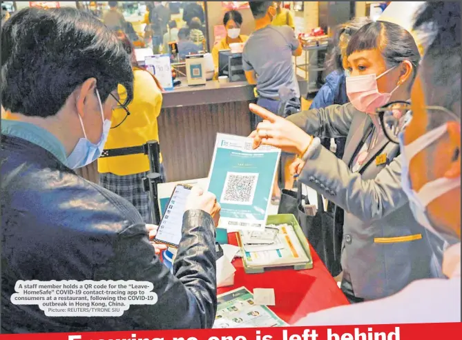  ?? Picture: REUTERS/TYRONE SIU ?? A staff member holds a QR code for the “LeaveHomeS­afe” COVID-19 contact-tracing app to consumers at a restaurant, following the COVID-19 outbreak in Hong Kong, China.