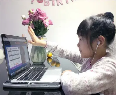  ?? PROVIDED TO CHINA DAILY ?? Yang Zixuan, 8, a student at Beijing No 2 Experiment­al Primary School learns English through VIPkid online courses.