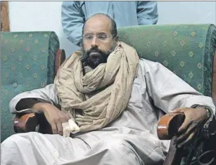  ?? AP PHOTO ?? Seif al-Islam is seen after his capture in the custody of revolution­ary fighters in Zintan, Libya, in November 2011. A court in the Libyan capital has sentenced al-Islam, Moammar Gadhafi’s son, to death over killings during the country's 2011 uprising.