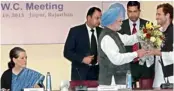  ?? — PTI ?? Prime Minister Manmohan Singh greets Rahul Gandhi after he was appointed vice-president of the Congress in Jaipur on Saturday. Also seen in the photograph is party president Sonia Gandhi.