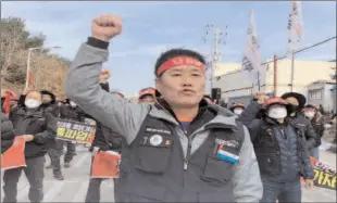  ?? -REUTERS ?? SEOUL
Unionized truckers shout slogans during their rally as they kick off their strike in front of transport hub South Korea.