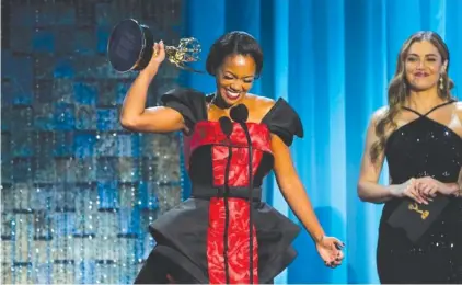  ?? AP PHOTO/CHRIS PIZZELLO ?? Mishael Morgan accepts the award for outstandin­g performanc­e by a lead actress in a drama series for her role in “The Young and the Restless” on Friday at the 49th annual Daytime Emmy Awards in Pasadena, Calif.