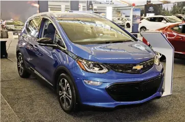  ?? GENE J. PUSKAR AP, file 2020 ?? A 2020 Chevrolet Bolt electric car is displayed in Pittsburgh. On Thursday, General Motors said a pending breakthrou­gh in battery chemistry will cut the price of its electric vehicles so they equal those powered by gasoline within five years.