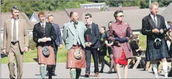  ??  ?? HRH the Princess Royal with her husband Sir Timothy Laurence is met at Oban High School by head boy Angus Files, head teacher Peter Bain and senior depute Kevin Champion.