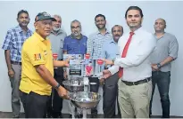  ??  ?? Rainco Pvt Ltd COO Ahamed Aroos handing over washing stations to a representa­tive of Rotary Club Colombo Midtown