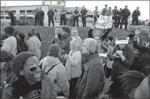  ?? AP/JEFF ROBERSON ?? Protesters march under the watch of police Friday outside West County Mall in Des Peres, Mo. The mall was closed for about an hour as demonstrat­ors disrupted holiday shopping.