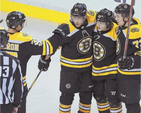  ?? STAFF PHOTO BY MATT STONE ?? ALL TOGETHER: Patrice Bergeron, Ryan Spooner and Charlie McAvoy celebrate a goal by Torey Krug (second from right) during the second period of last night's game at the Garden.