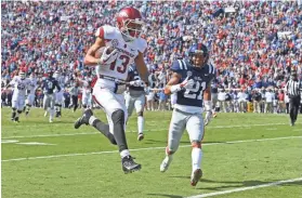  ?? THOMAS GRANING, AP ?? Arkansas receiver Deon Stewart (13) runs past Mississipp­i defensive back Javien Hamilton for a touchdown during the first half of an NCAA college football game in Oxford, Miss., Saturday, Oct. 28, 2017.