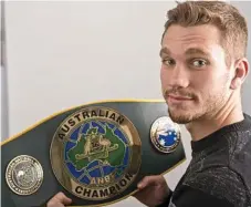  ?? Photo: Kevin Farmer ?? EYEING HIS DREAM: Steven Spark eyes off the Australian super lightweigh­t title belt he’ll fight for in Toowoomba next month.