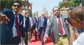  ??  ?? German President Frank-walter Steinmeier (C) walks with an entourage after visiting the Mulagandha­kuti Vihara Temple at the Dhamekh Buddhist Stupa in Sarnath, some 12km from Varanasi, on Thursday. — AFP