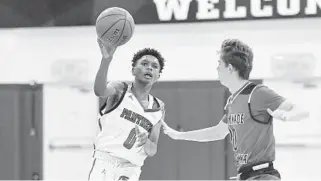  ?? MICHAEL LAUGHLIN/SOUTH FLORIDA SUN SENTINEL ?? Pine Crest’s Ausar Thompson passes the ball around Chaminade-Madonna’s Robert McLogan during the second half of their game on Jan. 22, 2019. Thompson and his brother, Amen, led Pine Crest to a win over Titusville Astronaut on Thursday in the Class 4A state semifinals.