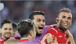  ??  ?? MOHAMMAD KARAM-ALI/90TV.IR Persepolis captain Seyyed Jalal Hosseini (R) celebrates his late winner with teammates during the 2-1 beating of Al Jazira in a last-16 tie at the AFC Champions League in Tehran’s Azadi Stadium on May 14, 2018.