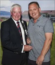  ??  ?? President’s Prize runner-up Trevor Giff is congratula­ted by Noel McGuinness.