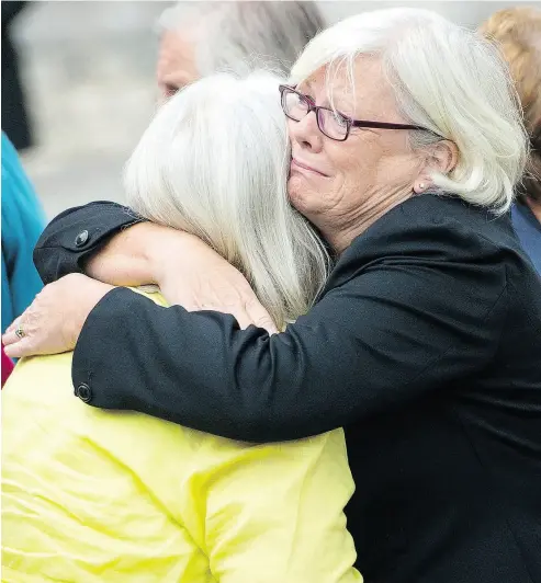  ?? DOMINIC LIPINSKI / PA VIA THE ASSOCIATED PRESS ?? Family of patients who died at Gosport War Memorial Hospital comfort each other Wednesday.